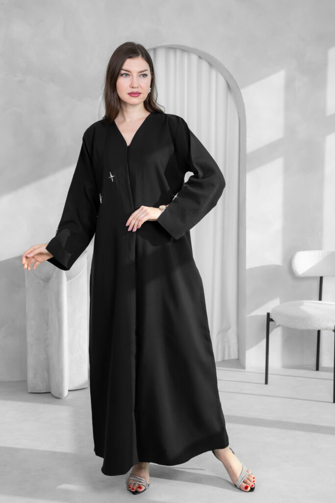 Discover understated luxury with this black abaya from Teblux. Crafted from premium crepe fabric and finished with crystal buttons that add a subtle touch of elegance. Perfect for work, travel, or everyday sophistication.